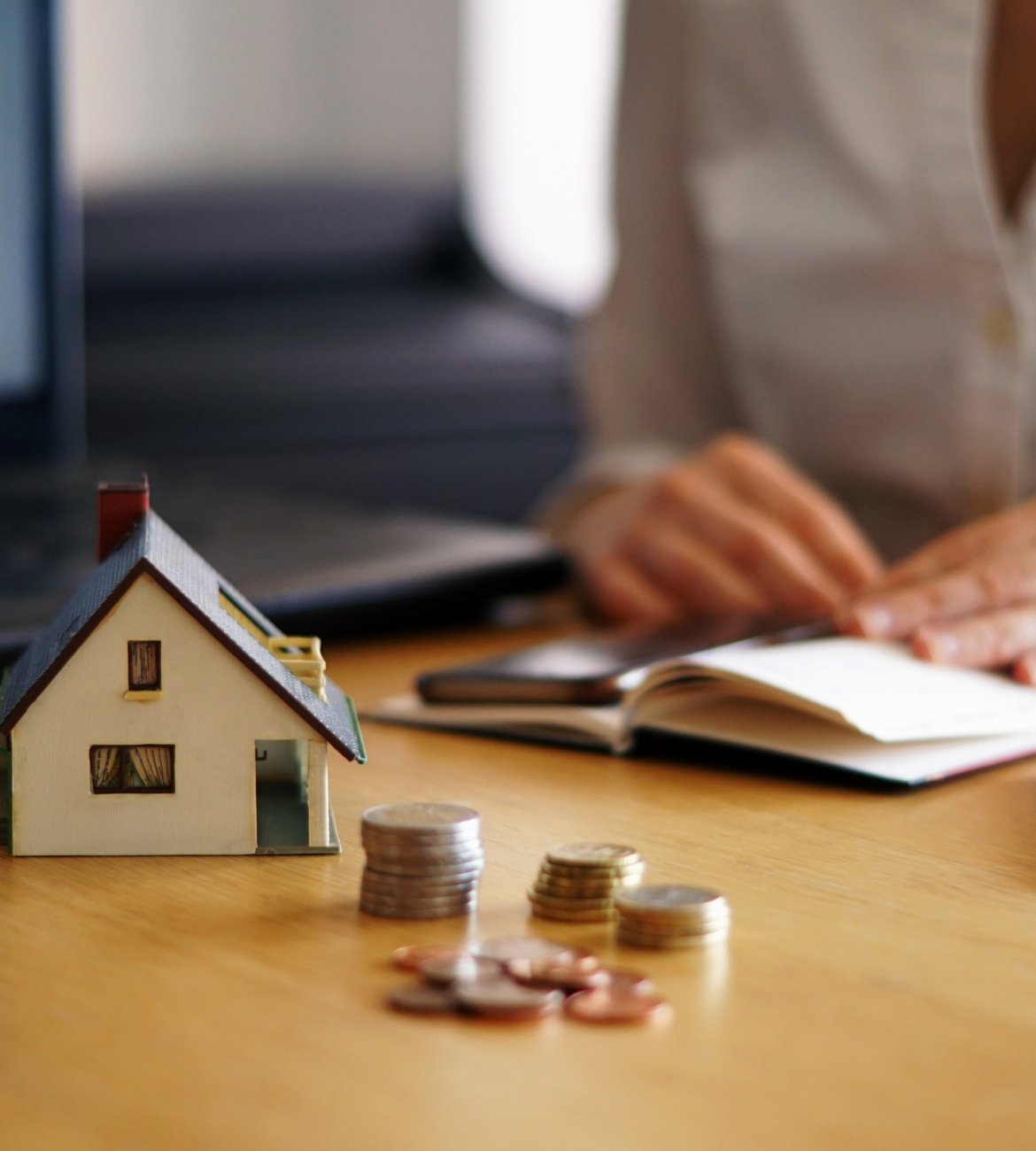 A closeup shot of a person thinking of buying or selling a house